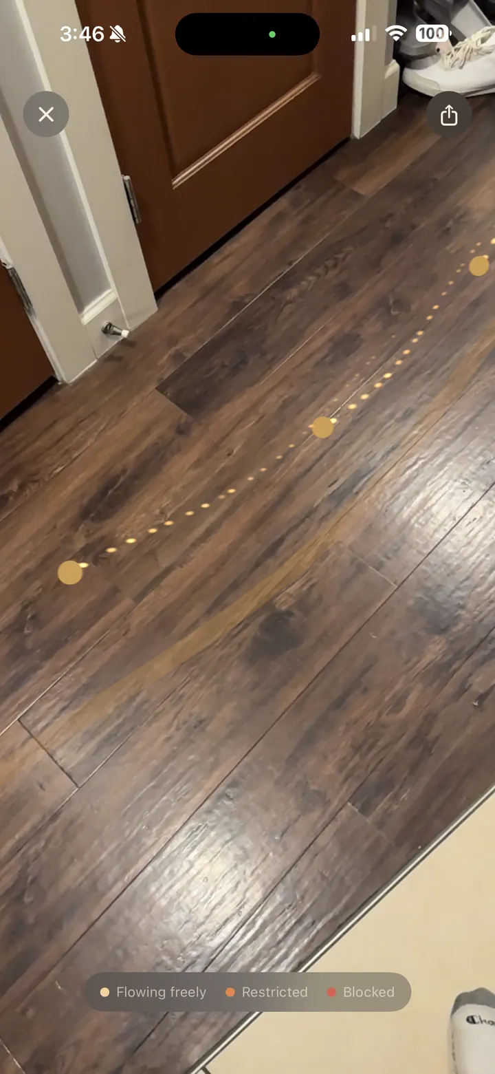 The flow path drawn as a line of light along a hallway floor in AR